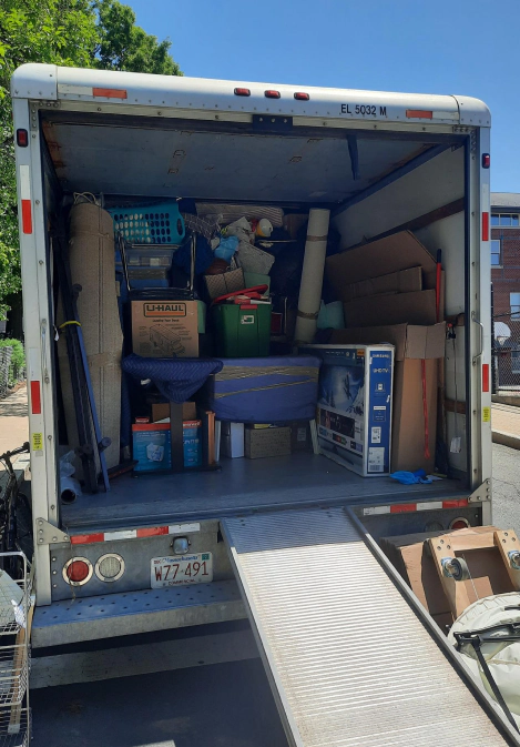 moving stuff inside of a white moving truck