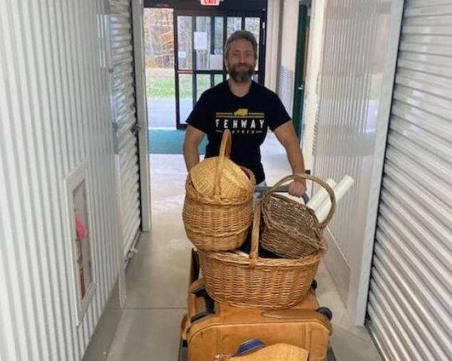 worker carrying some baskets in the middle of a halfway